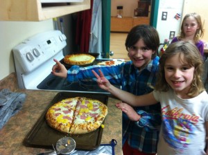 First we cut the pizza into halves. Each piece is 1/2 of the pizza.